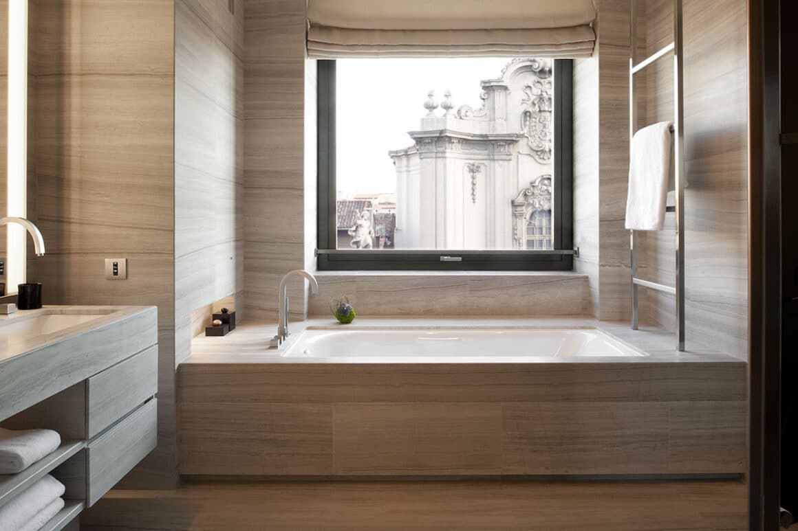 Indulge in luxury with this elegant bathroom suite, where modern design meets historic views, available with Natlaupa.