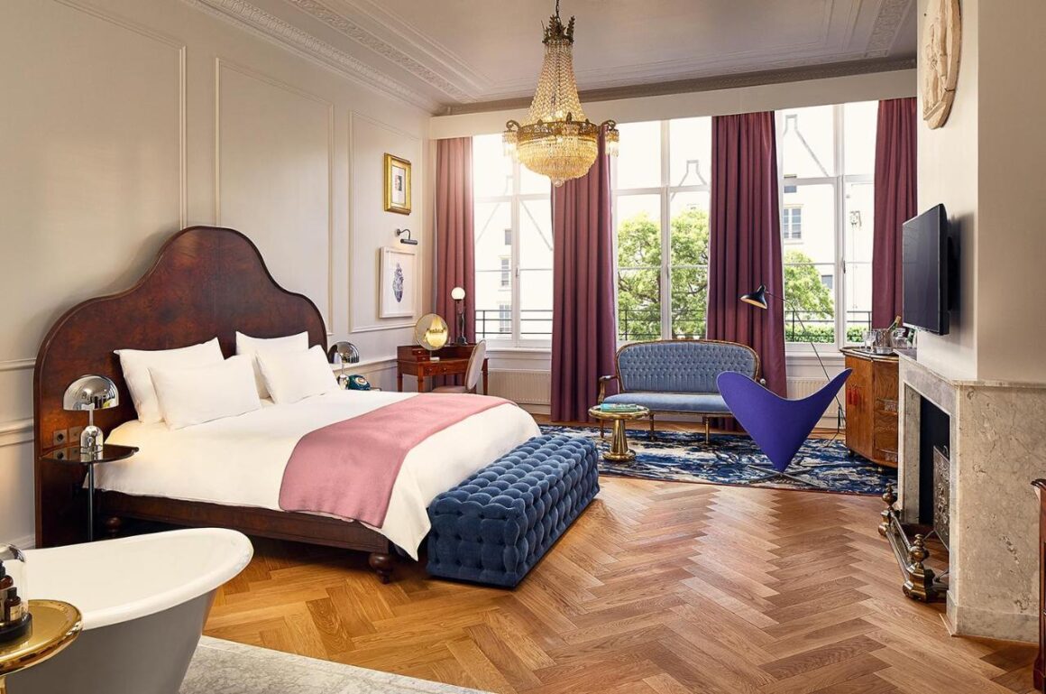 Luxurious hotel room at Le Pulitzer Amsterdam with elegant décor and modern amenities, available with Natlaupa.