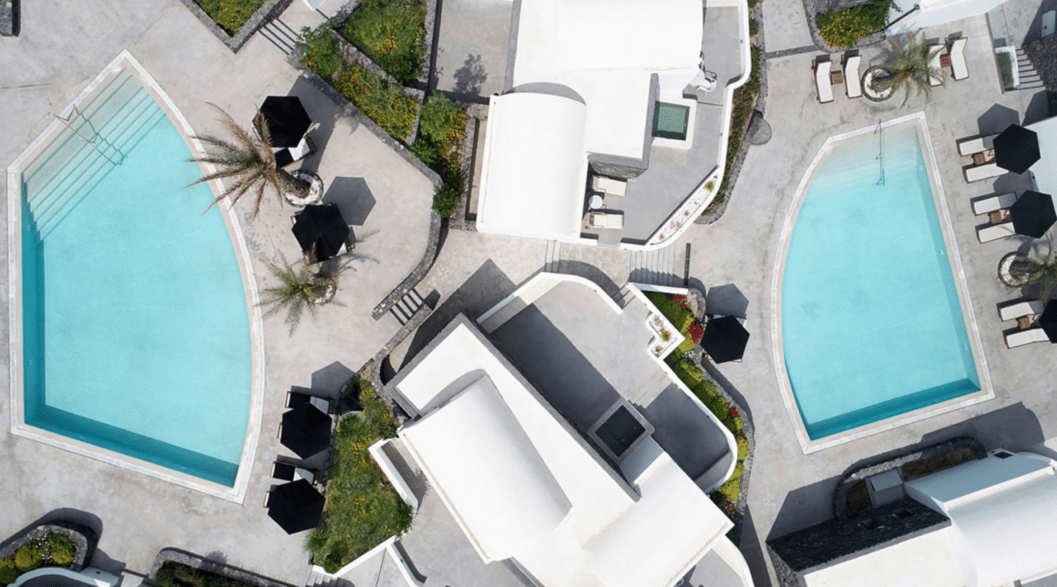 Experience luxurious outdoor living at Santo Maris Oia with Natlaupa, featuring stunning pools and serene surroundings.