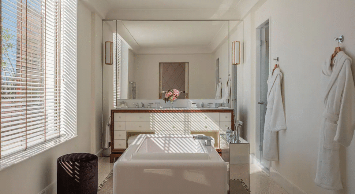 Experience ultimate relaxation at Hotel Martinez with Natlaupa, featuring a beautifully designed, light-filled bathroom sanctuary.