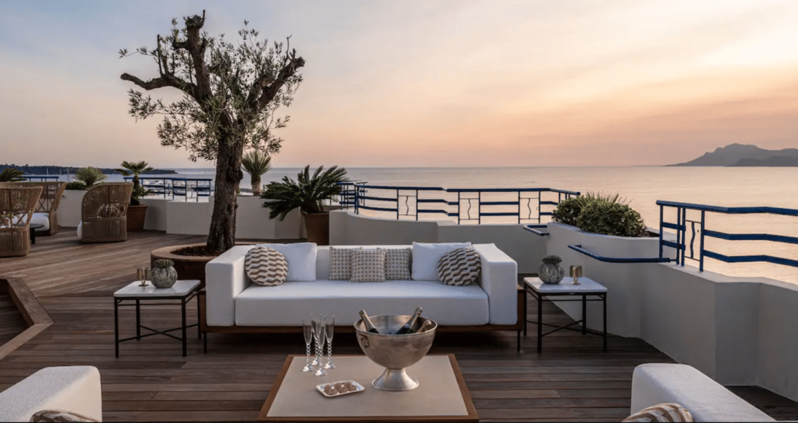 Experience unmatched luxury at Hotel Martinez with Natlaupa, featuring a serene terrace with stunning Mediterranean views and elegant seating.